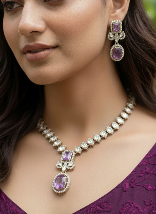 Woman wearing a purple necklace and earrings with a blurred green background