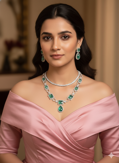 Woman wearing a pink off-shoulder dress with emerald and diamond jewelry.